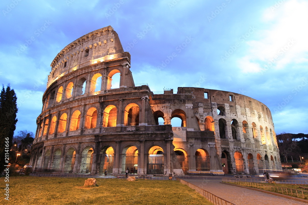 illuminated Colosseum at twilight in Rome