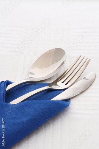Spoon fork and knife in blue napkins