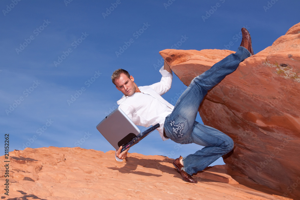 Man catching his falling laptop