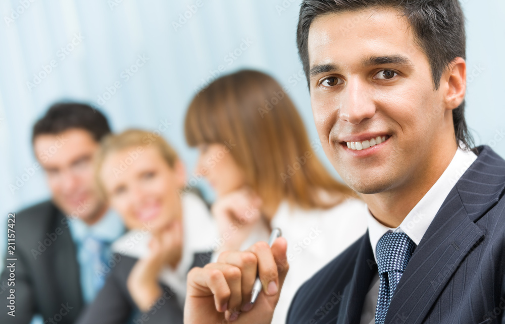 Portrait of successful businessman and business team at office m Portrait of successful businessman and business team at office m