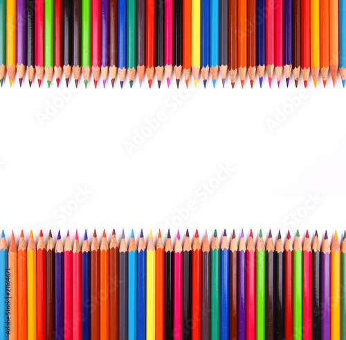 Assortment of coloured pencils with shadow on white background.