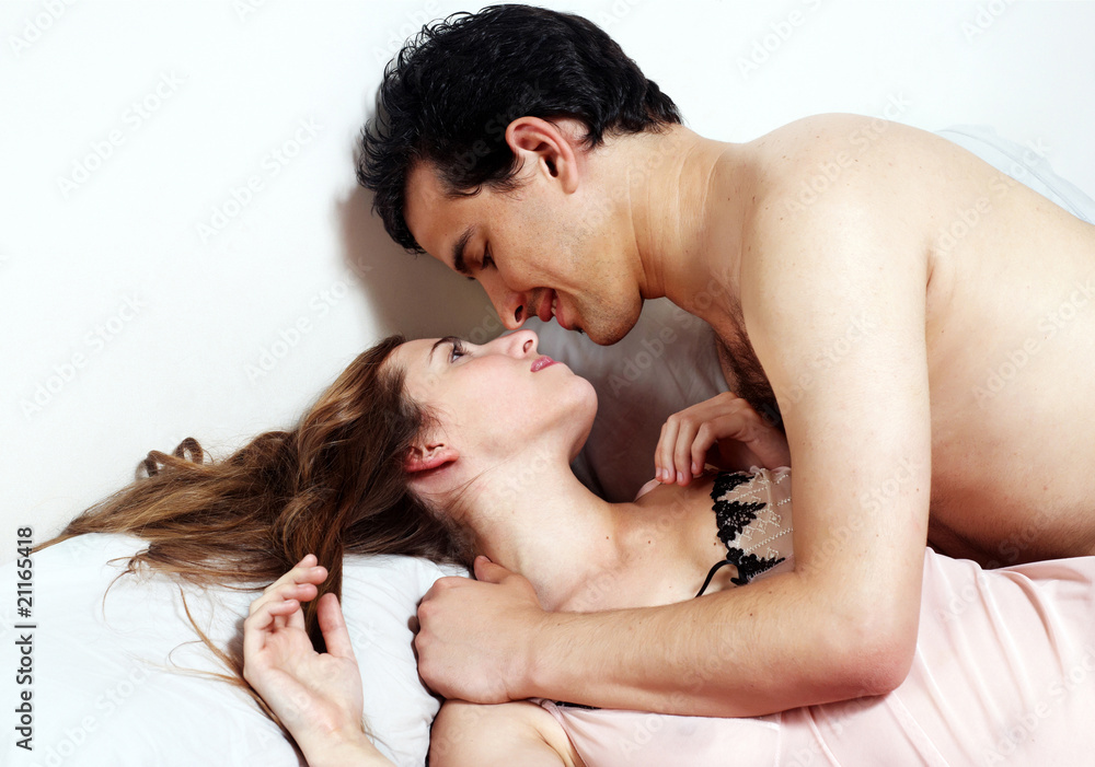 Fototapeta premium Young attractive happy couple in bedroom