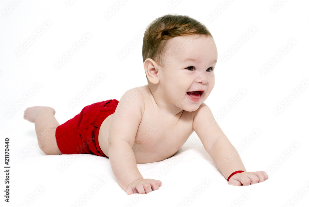 Portrait of the little boy in red shorts on a light background Portrait of the little boy in red shorts on a light background