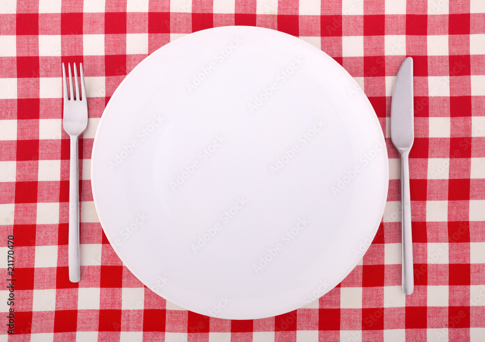 Tablecloth with fork, knife and an empty plate Tablecloth with fork, knife and an empty plate