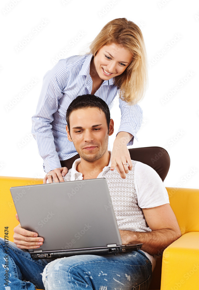 Happy couple on sofa with laptop computer