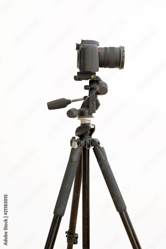 Digital SLR camera on a tripod isolated on white Digital SLR camera on a tripod isolated on white