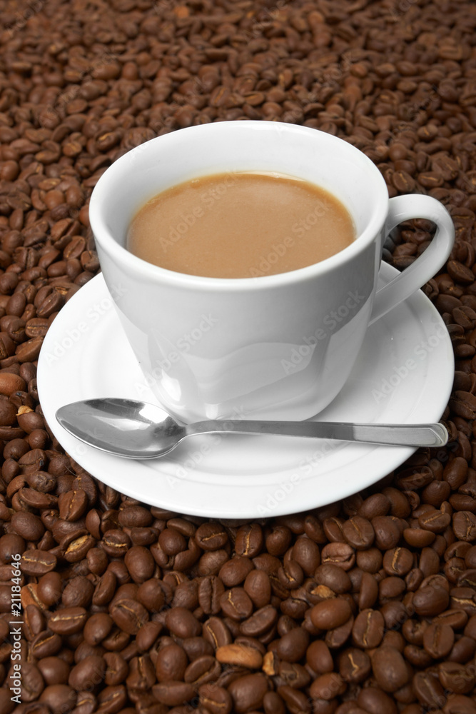Cup with coffee, costing on coffee grain Cup with coffee, costing on coffee grain