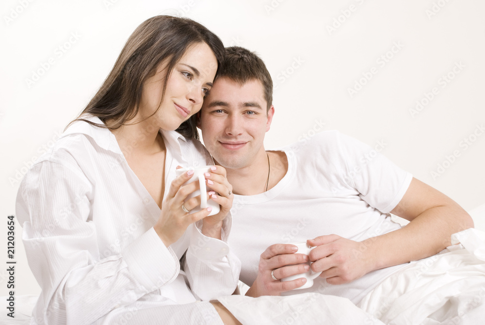 Young couple having breakfast in bed. Young couple having breakfast in bed.