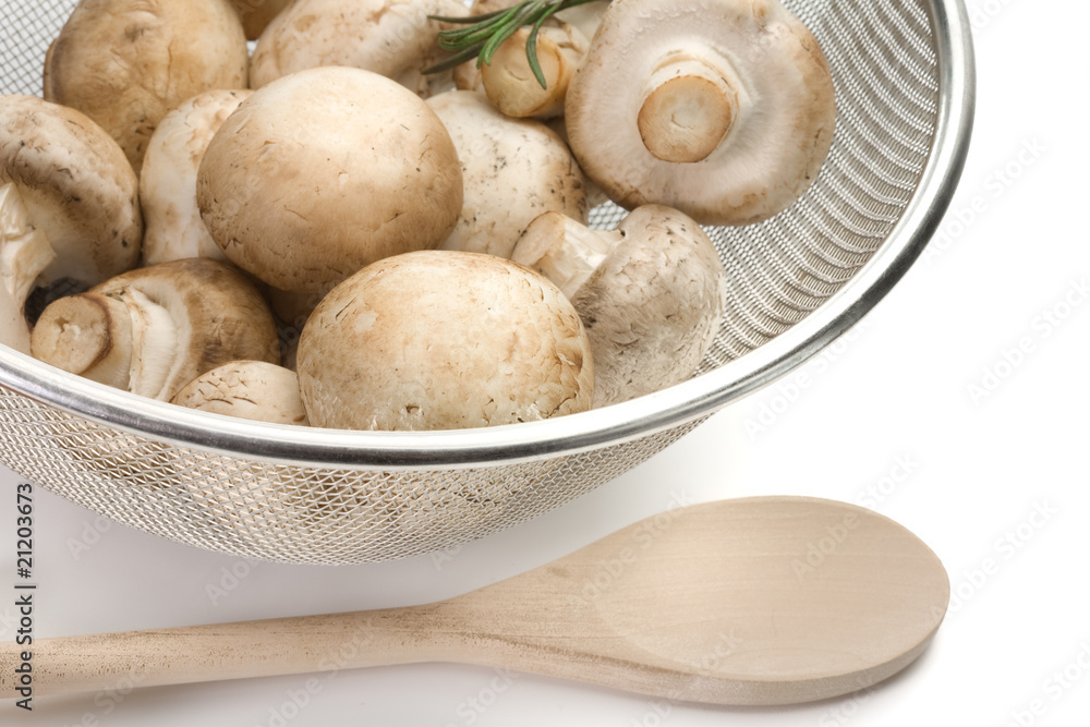 Colander of fresh-cut mushrooms champignon Colander of fresh-cut mushrooms champignon