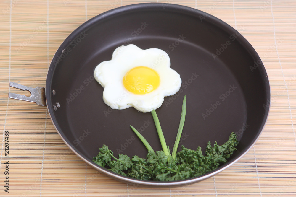Flower shaped fried egg with greenery