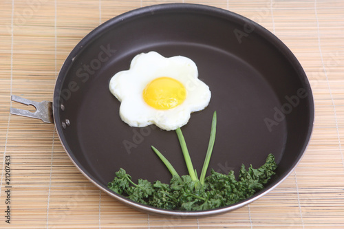 Flower shaped fried egg with greenery