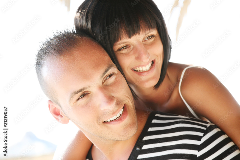 Portrait of a happy young couple enjoying summer holidays. Portrait of a happy young couple enjoying summer holidays.