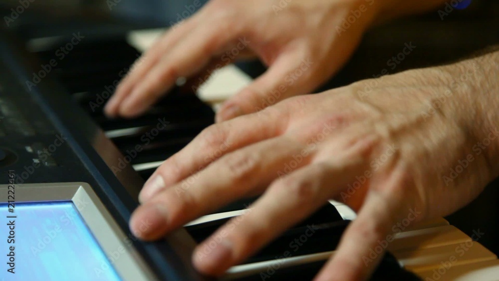 unidentified keyboard player playing on synthesizer, close-up unidentified keyboard player playing on synthesizer, close-up