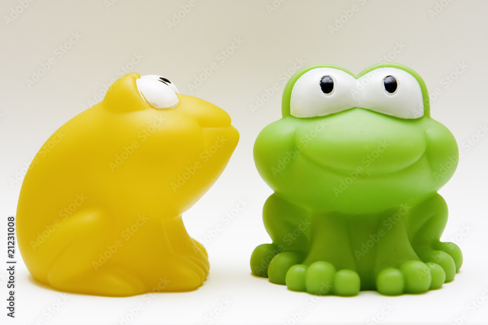 toy rubber blue and yellow frogs on white background toy rubber blue and yellow frogs on white background