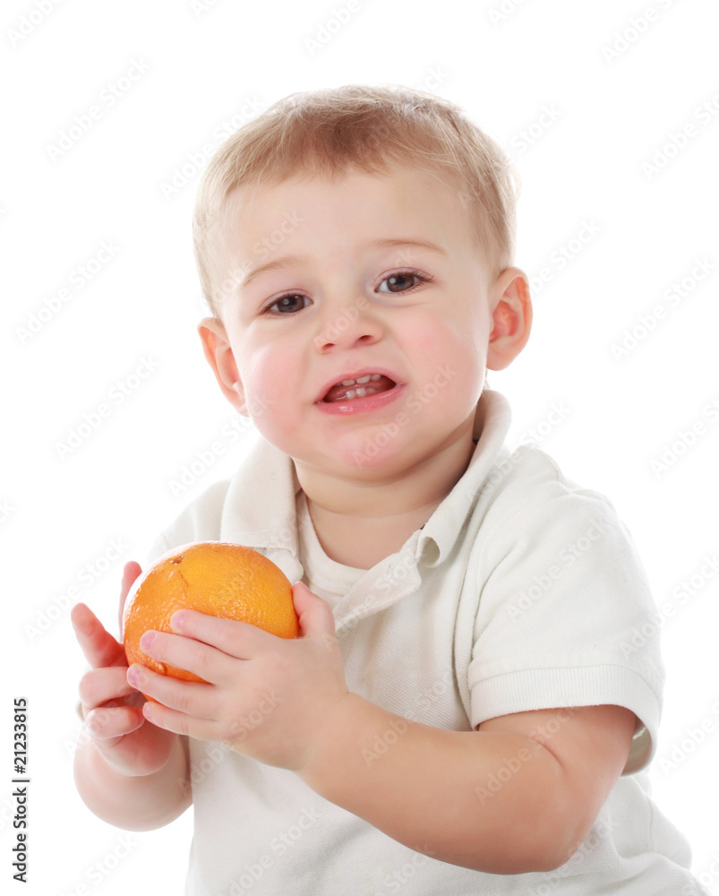 baby boy holding an orange