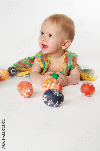 Baby girl playing with Easter eggs