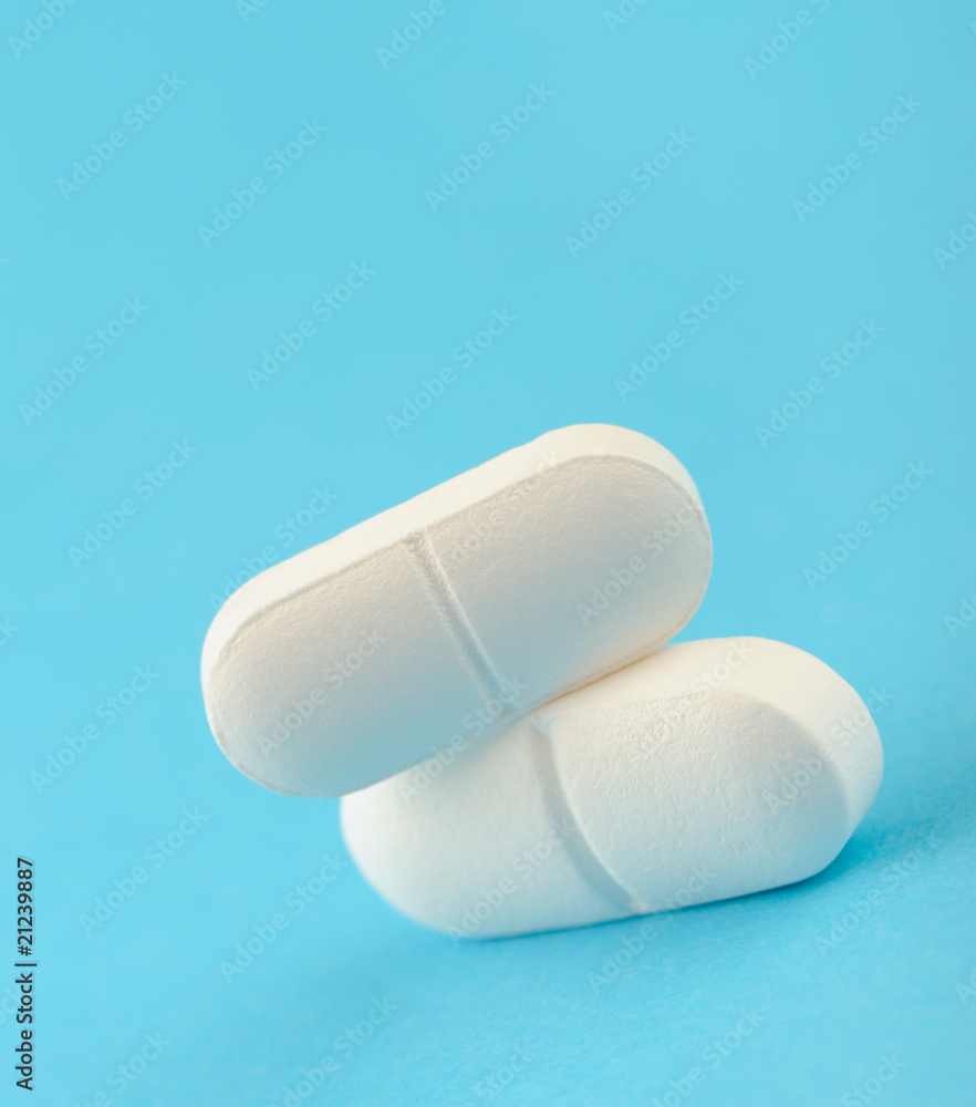 Two white tablet on a blue background.