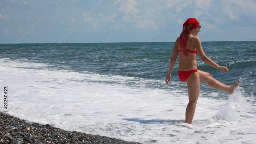 beautiful woman dressed in swimsuit walking in sea surf beautiful woman dressed in swimsuit walking in sea surf