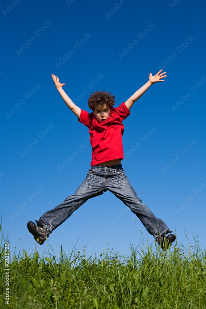 Boy jumping, running against blue sky Boy jumping, running against blue sky
