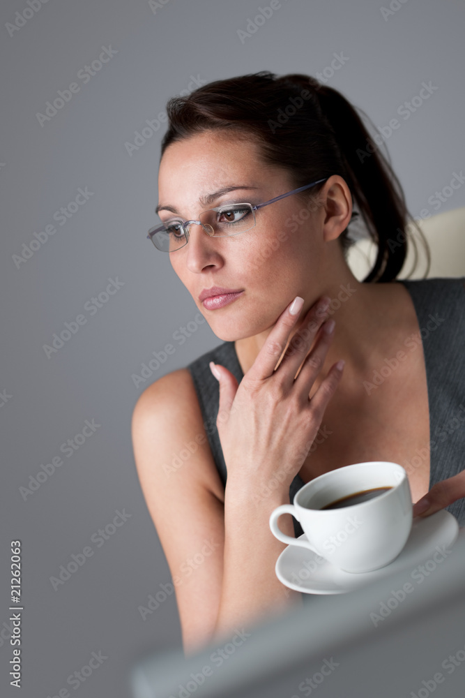 Successful business woman having coffee break at office Successful business woman having coffee break at office