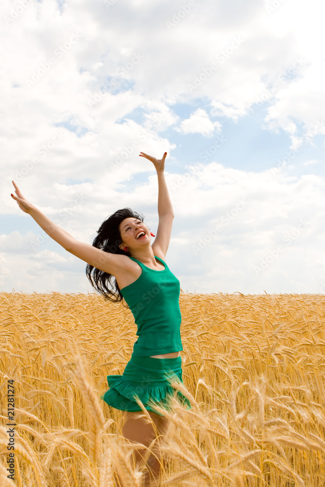 Happy woman jumping in golden wheat Happy woman jumping in golden wheat