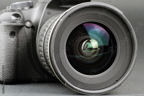 Close-up of lens with camera body on black background