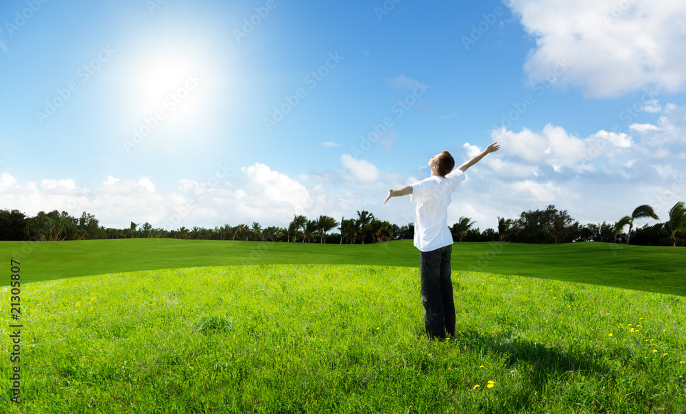 young man relax on the green field young man relax on the green field