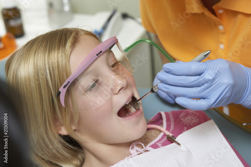 girl  7-10  having teeth examined at dentists  close-up 