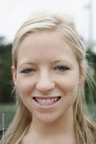 young woman smiling outside close-up portrait