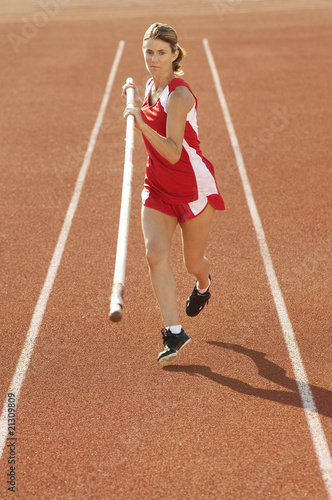 athlete running with pole vault © moodboard