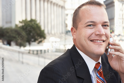 businessman using mobile phone outdoors portrait