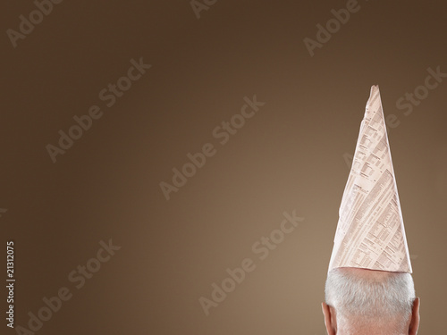 man wearing dunce hat high section back view