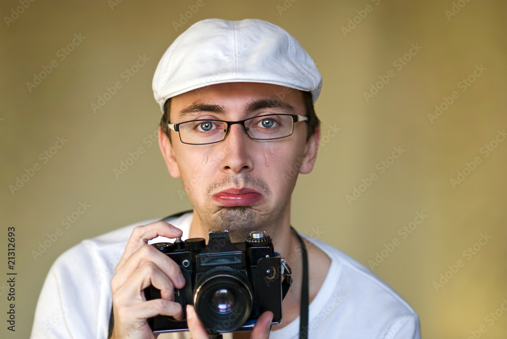 Isolated photographer with camera is crying Isolated photographer with camera is crying