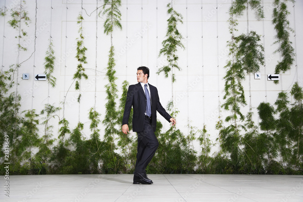 businessman looking over shoulder outdoors businessman looking over shoulder outdoors
