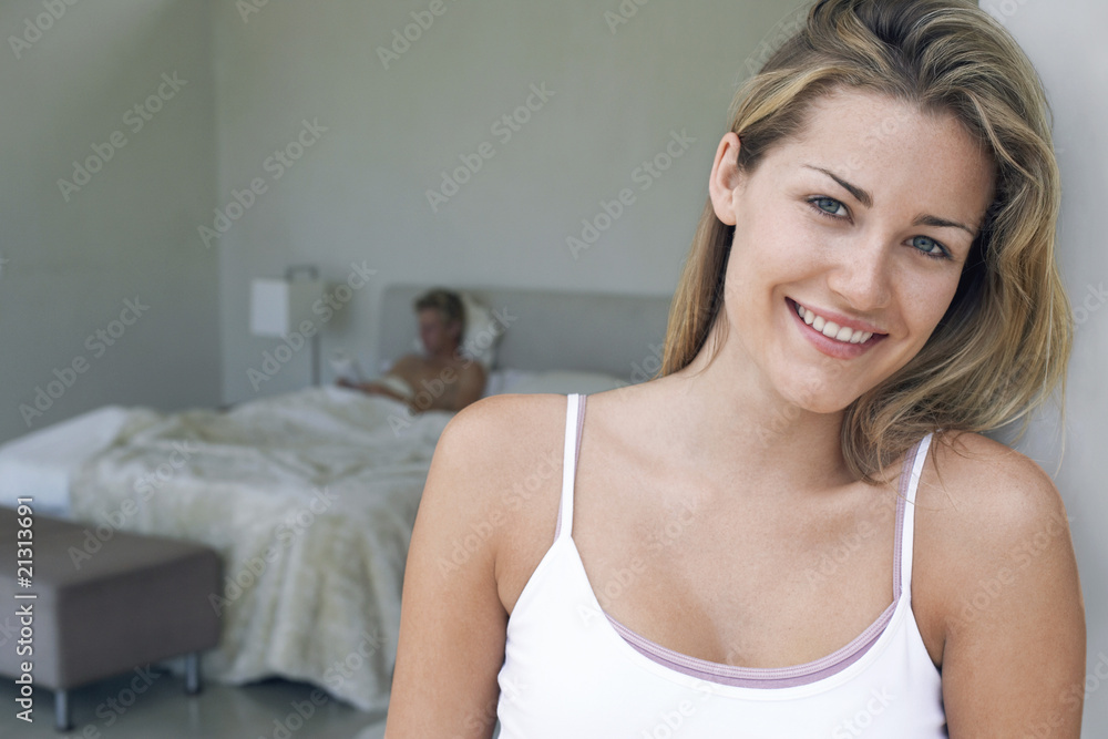 couple in bedroom focus on smiling woman in foreground portrait