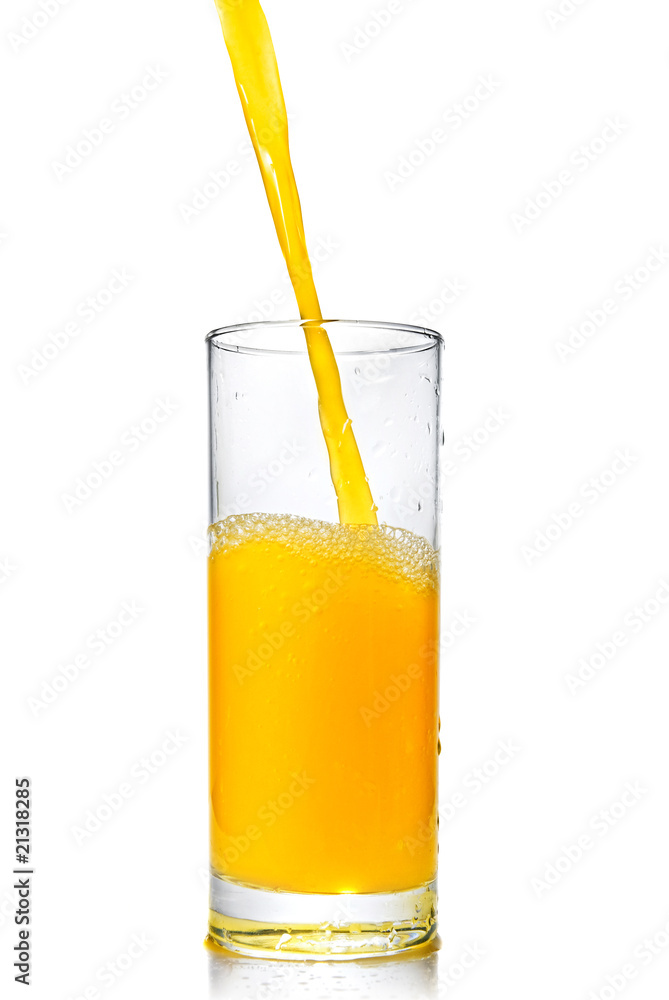 orange juice poring into glass isolated on white orange juice poring into glass isolated on white
