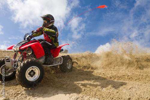 ATV rider spray sand in dunes