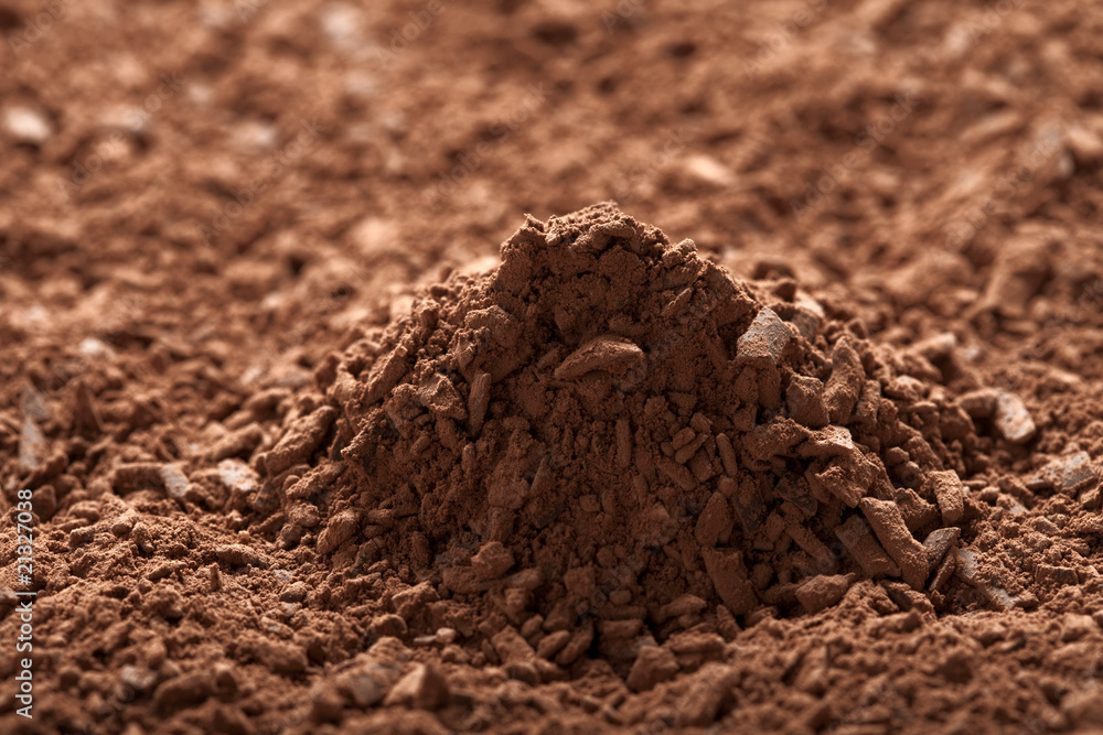 pile of cocoa powder with small pieces of chocolate background pile of cocoa powder with small pieces of chocolate background