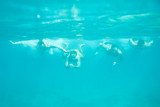 Four men swimming underwater