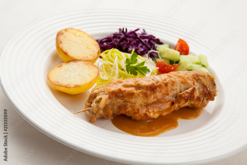 Roasted stuffed pork chop with chips and vegetables Roasted stuffed pork chop with chips and vegetables