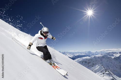 Female skier with sun