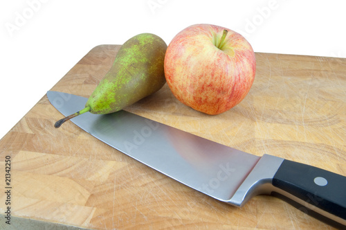 apple and pear on chopping board with knife