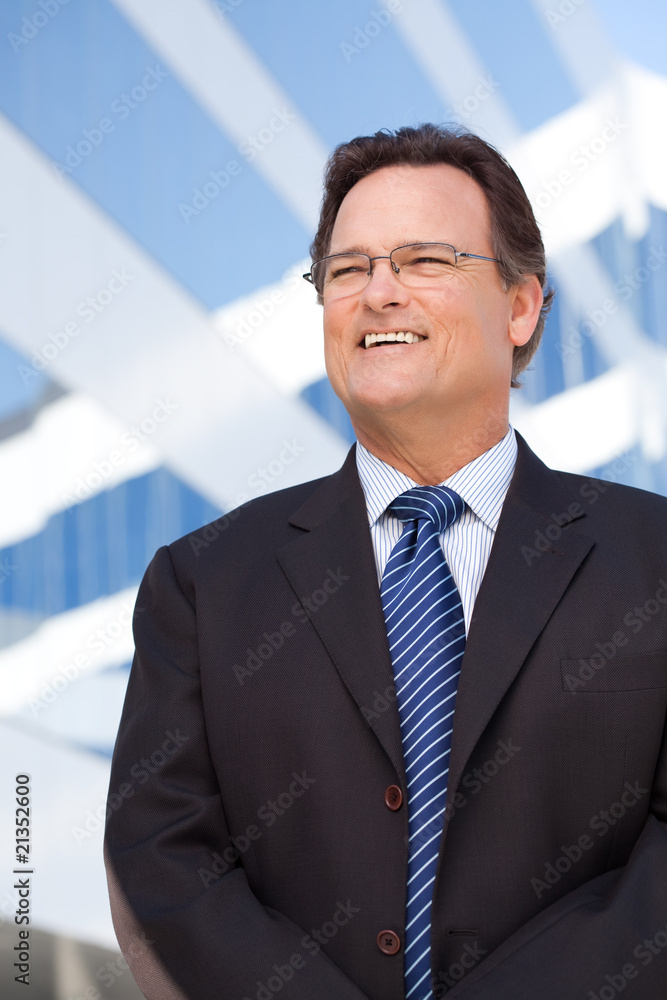 Handsome Businessman Smiling in Front of Building Handsome Businessman Smiling in Front of Building