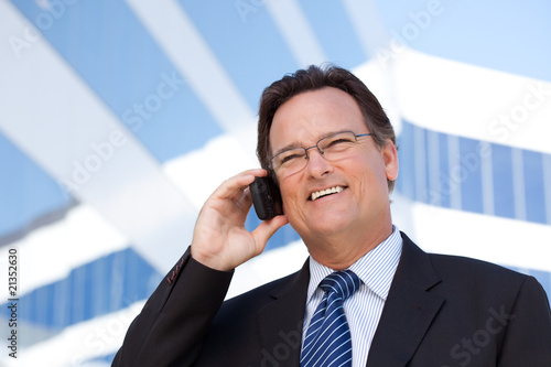 Businessman Smiles as He Talks on His Cell Phone