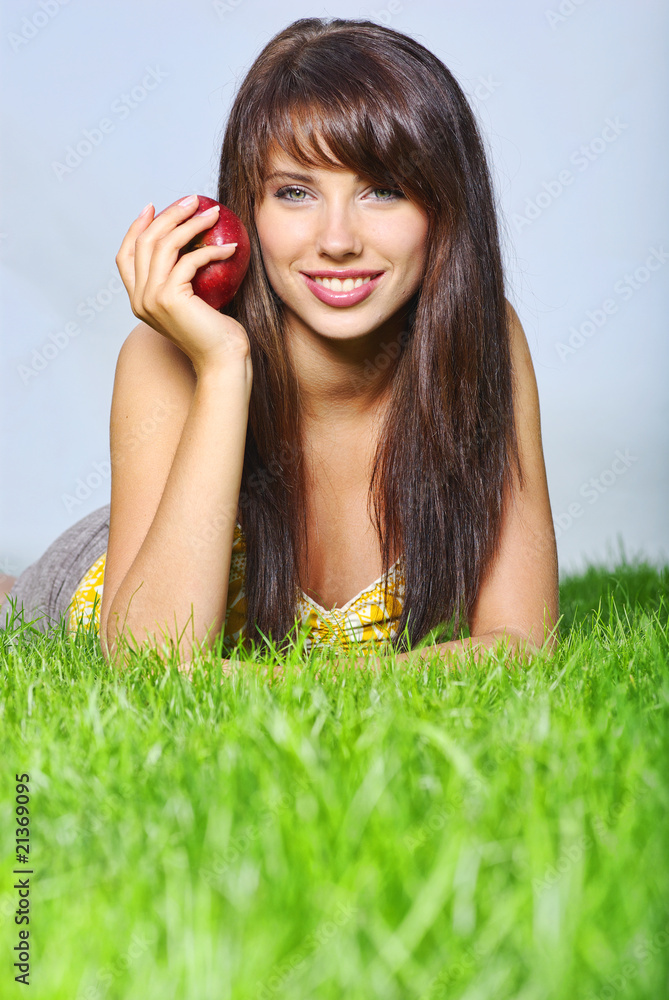 Smiling beautiful woman laying on grass Smiling beautiful woman laying on grass
