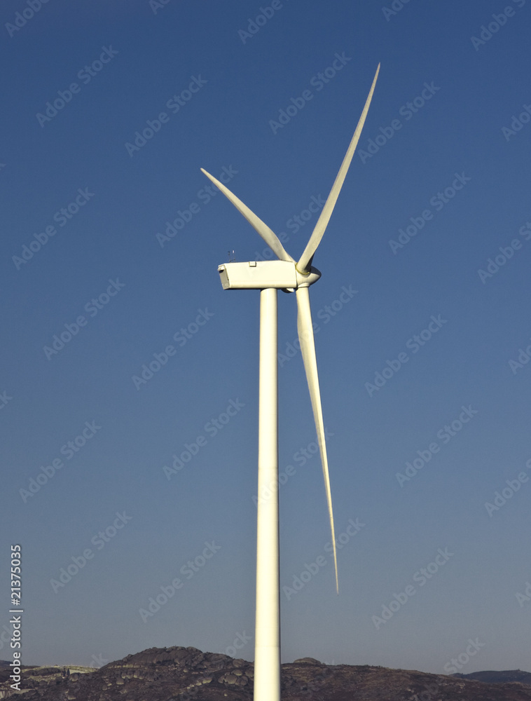 windmil in the top of a montain with blue sky, alternative energ windmil in the top of a montain with blue sky, alternative energ