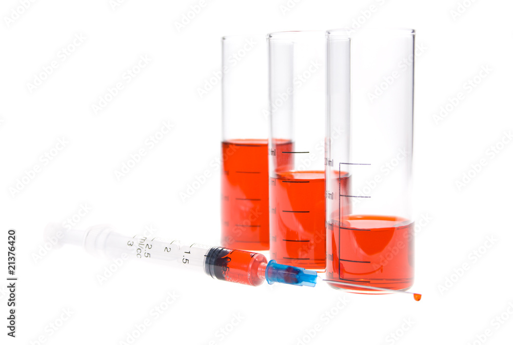 tubes and syringe with red liquid  on a white background