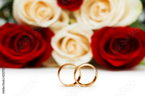 Roses and wedding ring isolated on the white