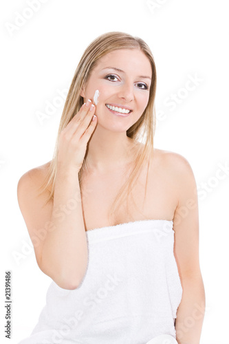 White caucasian blonde woman creaming face