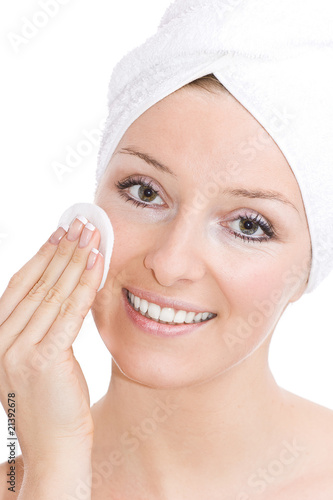 caucasian woman cleaning face after makeup